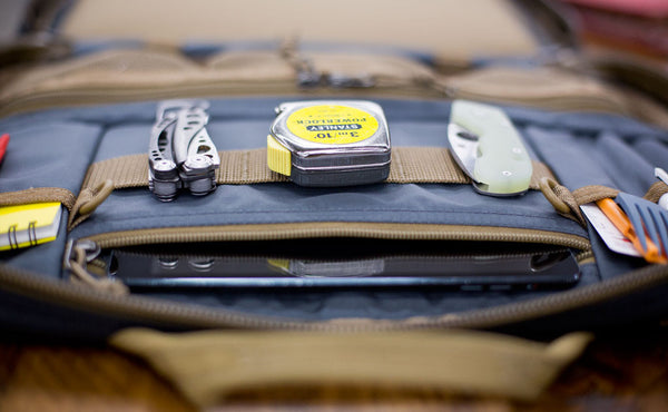 A close shot of the webbing loops with tools attached on the interior of the Founder's Briefcase.